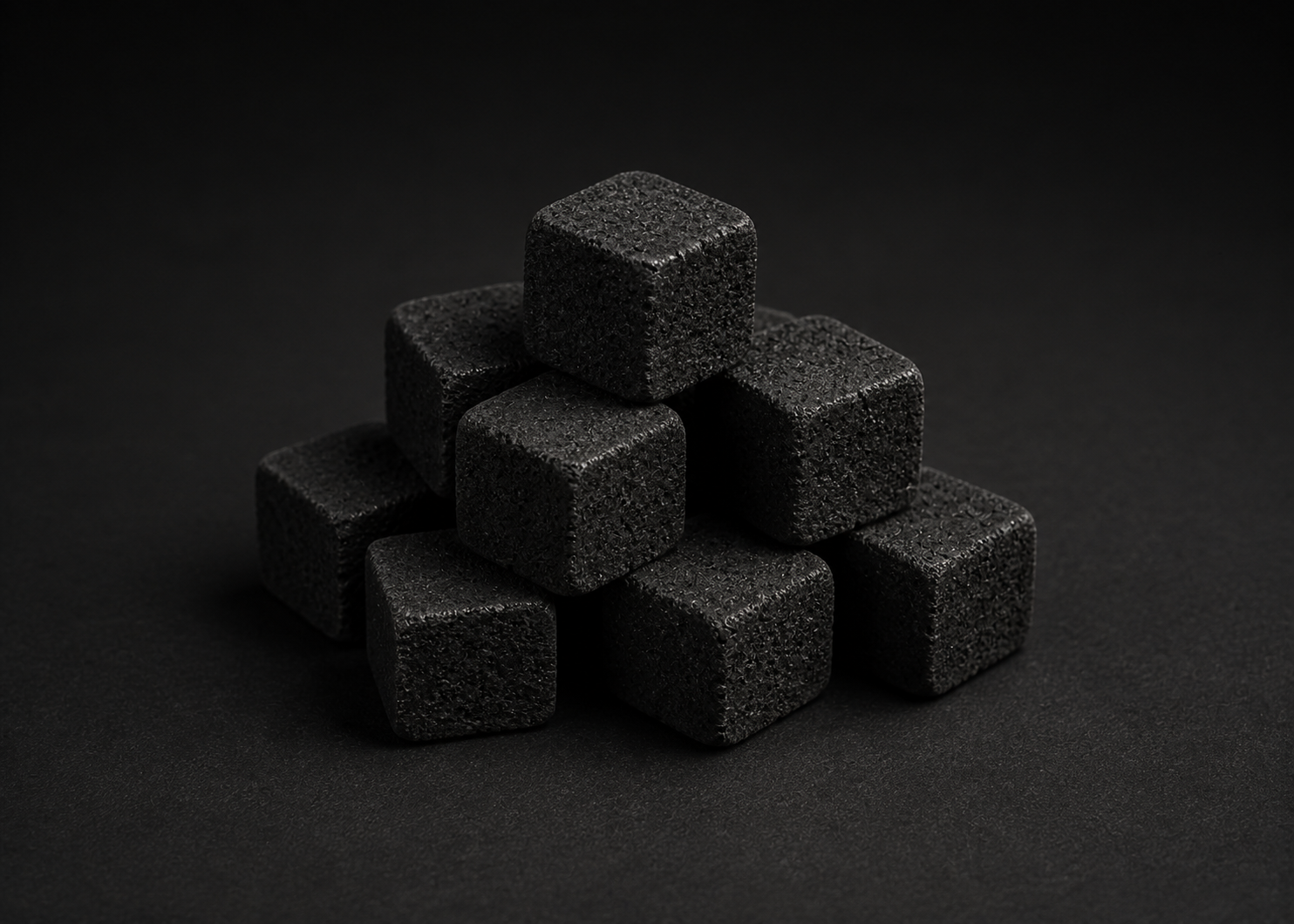 Illustrative group of unlit cube-shaped coconut-shell charcoal pieces